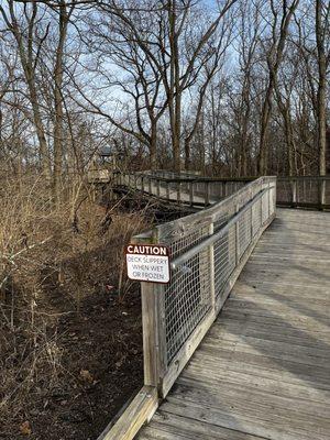 Walking bridge that winds through the wooded area