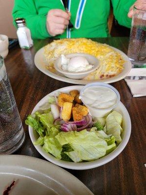 Balanced living. Salad and a plate of hashbrown special