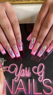 Acrylic nails with French designs and rhinestones