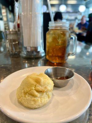 A biscuit while waiting for the food, accompanied by peach jam.