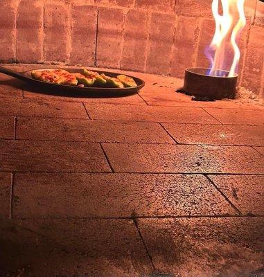 Appetizer, peppers (poppers) baking in a genuine Italian brick oven.  A favorite among their regular customers.