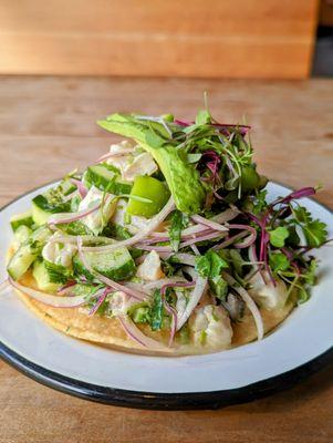 Green Fish Ceviche Tostada with sustainable fish, avocado, key lime, jalapeño, tomatillo milpero, red onion, cilantro, jalapeño aioli