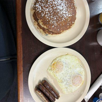 Eggs over easy, sausage and pancakes.