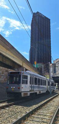 Light rail, buses, and inclines (funiculars) make up PRT; this is a "T" train downtown in the Golden Triangle, with the UPMC Tower beyond.