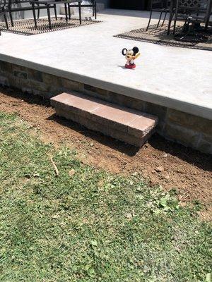 The step that was installed which is not what we verbally agreed on, nor do the RED pavers match the white/beige concrete and stone veneer.