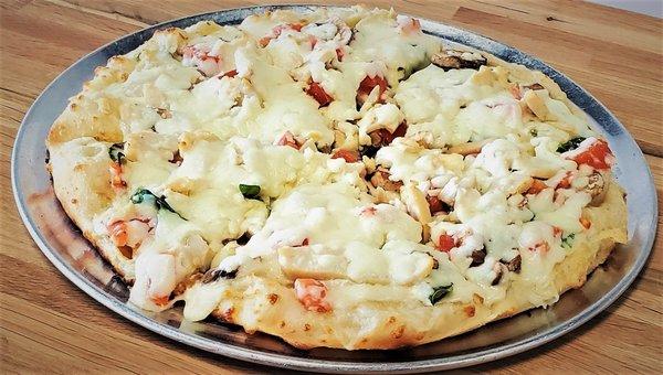 Chicken Alfredo Pizza:  Roasted Chicken Breast, Spinach, Mushroom, Diced Tomato, Alfredo Sauce, and Mozzarella