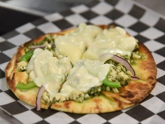 We have flat breads..... This is our chicken pesto flatbread with provolone.