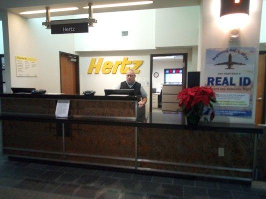 The pictured Hertz agent is uninterested in your needs, questions, or concerns. He is just going through the motions.