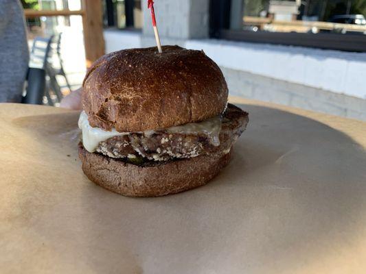 Black bean patty with Swiss on whole wheat bun.