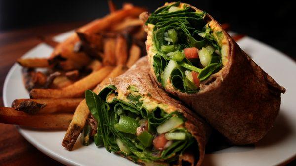 Fresh  Garden Veggie Wrap. Tomatoes, baby spinach, green peppers, cucumbers, red onions, roasted red pepper hummus, and avocado.