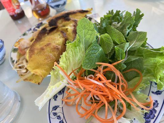 The crispy crepe served with lettuce leaves, mint, shredded carrots & daikon.