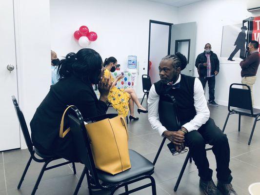 Timothy Sutton (On the Right) the business owner engaging with a patient on the grand opening.