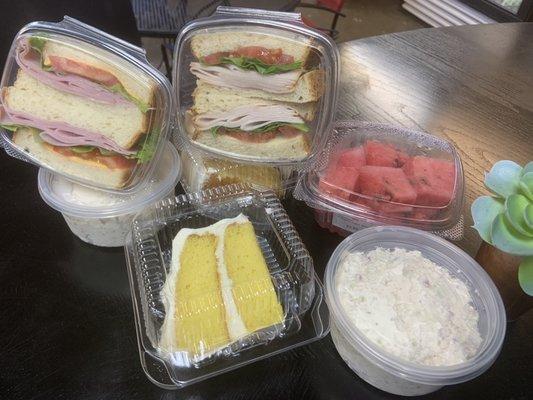 Daily grab and go items 
Homemade Lemon cake with cream cheese frosting 
Turkey and Ham sandwiches 
Watermelon 
Chicken salad