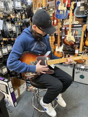 My 12 yr old finally found his new Love! A Fender American Professional in Sunburst! This is my 50,000 picture! I love it!