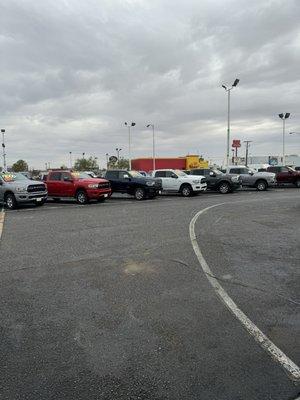 The parking lot full of trucks for sale.