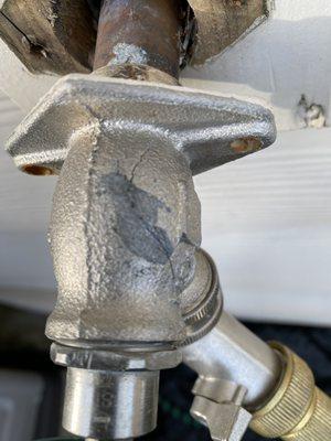 Old cracked outdoor water faucet after winter