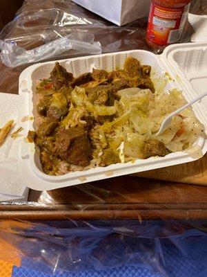 Curry goat and rice and peas and cabbage