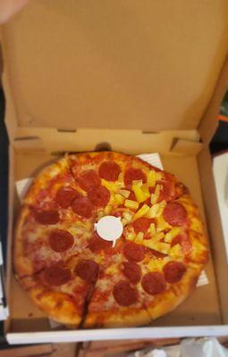 Pepperoni pizza and pineapple only on a couple of slices.