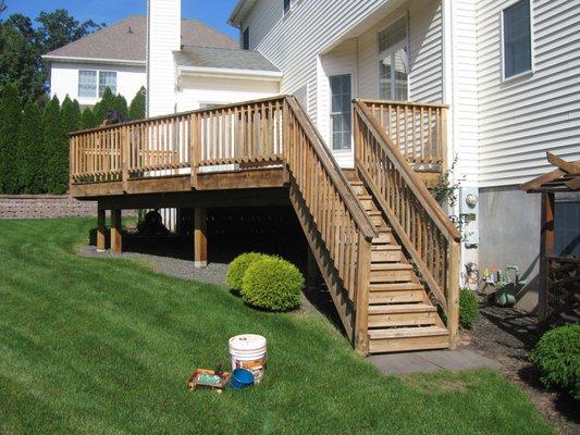 Cedar deck fully brightened and cleaned with eco safe deck detergents that won't raise wood grain or cause splintering of boards.