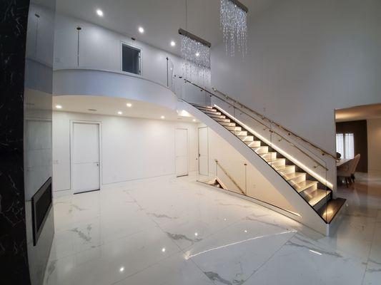 Grand entrance stair, dual steel stringer with overlook gallery and lighted treads.