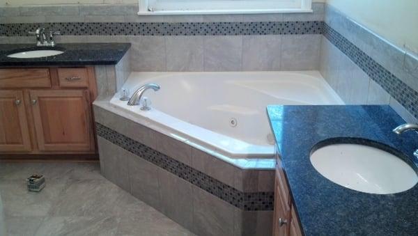 Tub hop with tile & glass across the front