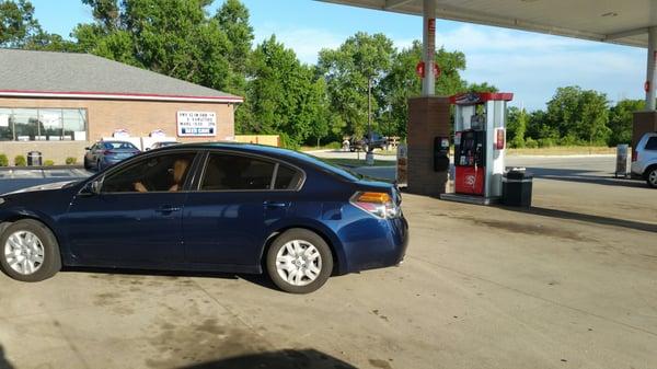 No idea why all the boneheads congregate at this gas station.  Yes, this car is sideways between the pumps!