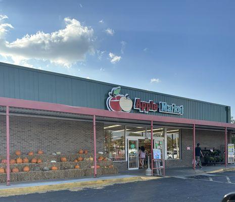 Entrance decorated with pumpkins and mums for purchase