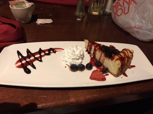 Homemade Cheesecake w/ puréed strawberries and blueberries.