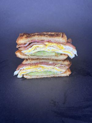 Fried Egg Sandwich. Fried egg, bacon, avocado, mayo, served on toasted bread.