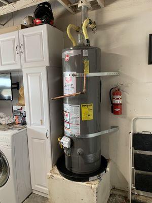 Installation of new water heater with upgraded drip pan.