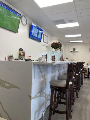 View of the bar seating from the last booth closest to the kitchen