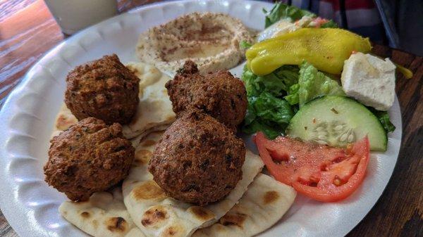 Jerusalem veggie plate that consists of falafel, hummus and Greek salad