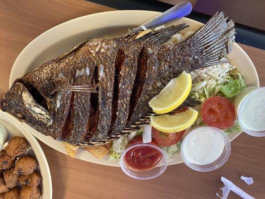 Whole fried fish (tilapia) with salad, and French fries