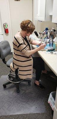 Colleen Bolte servicing a hearing aid