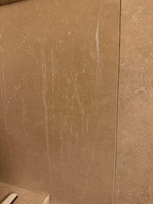 Chemical damage to travertine tile.