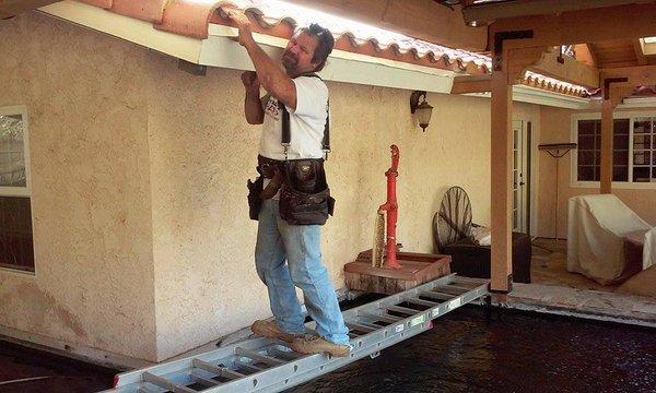 Here is BRG's owner putting up gutter over a beautiful koi pond