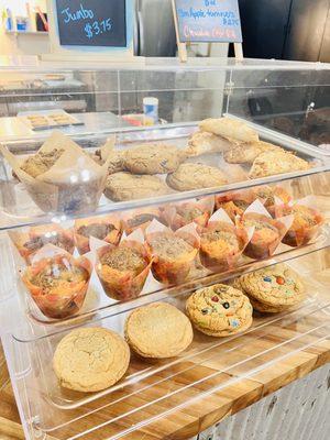 Bakery case with blueberry muffins, apple turnovers, snickerdoodles and m&m cookies