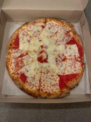 Cheese pizza. Cheese is a bit lopsided and appears to have been slapped on in squares.