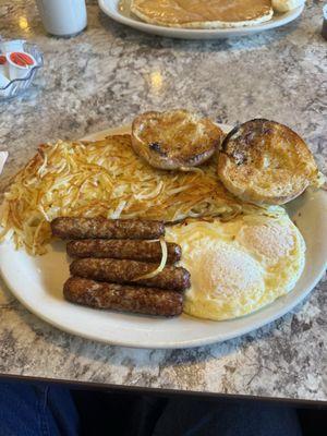 Link sausage and eggs over medium, hash browns and English muffin.