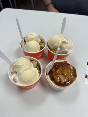 Two CARAMEL APPLE COBBLERS, MANGO PEACH COBBLER, and one strawberry peach cheesecake!