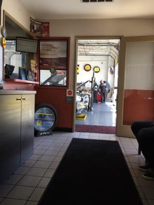 View of them working on cars from the waiting room.