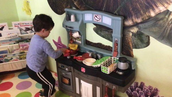 My son enjoying the play kitchen. :)