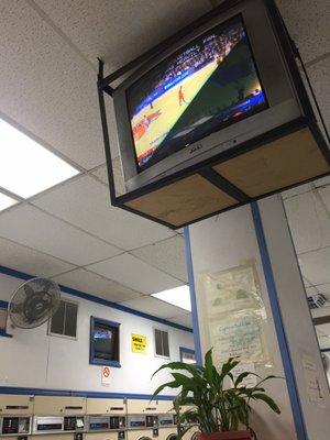 Catching the game at the laundromat