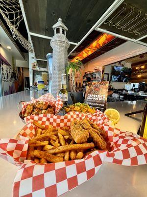 Chicken tender with cajun fries, soy garlic wings, and house signature cajun seafood fried rice