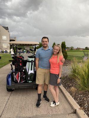 Clubs, cart, and driving range in the back.