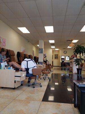 Plenty of pedicure chairs and manicure stations.