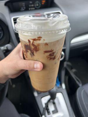 Iced coffee with fudge drizzle and sweet cream