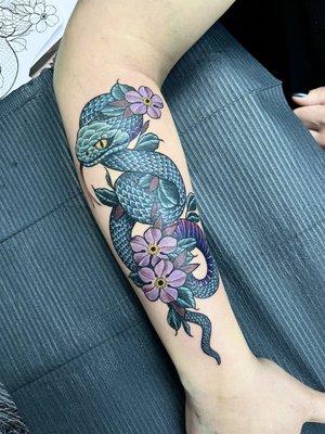 Viper snake with flowers tattoo by Krystal from Village Tattoo