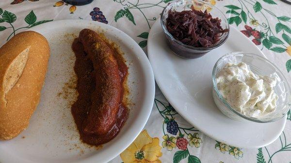 Curry wurst with a side of red cabbage and cucumber salad