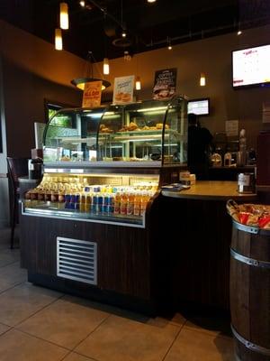 Pastries and cold bottled beverages stocked in the display case.